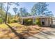 Ranch-style home with a large backyard and mature trees at 6677 Songwood Dr, Austell, GA 30168