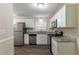 Renovated kitchen featuring white cabinets and granite countertops at 6677 Songwood Dr, Austell, GA 30168