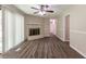 Spacious living room with brick fireplace and wood-look floors at 6677 Songwood Dr, Austell, GA 30168