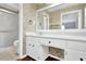 Bright bathroom with white vanity, large mirror, and shower at 4481 Nantucket Sw Dr, Lilburn, GA 30047