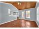Living room features hardwood floors, wood ceiling and access to kitchen at 4481 Nantucket Sw Dr, Lilburn, GA 30047
