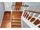 Hardwood staircase with white railings and entryway view at 4481 Nantucket Sw Dr, Lilburn, GA 30047