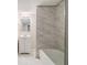 Basement bathroom with marble-look tile and vanity at 796 Vanderbilt Nw Ct, Atlanta, GA 30318