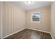 Well-lit bedroom with wood-look floors and neutral walls at 796 Vanderbilt Nw Ct, Atlanta, GA 30318