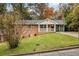 Brick ranch house with a covered porch and landscaped yard at 796 Vanderbilt Nw Ct, Atlanta, GA 30318