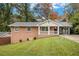 Brick ranch house with a covered porch and landscaped yard at 796 Vanderbilt Nw Ct, Atlanta, GA 30318