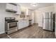 Kitchen with stainless steel appliances and wood-look flooring at 796 Vanderbilt Nw Ct, Atlanta, GA 30318