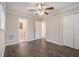 Main bedroom with ceiling fan, wood-look flooring, and access to bathroom at 796 Vanderbilt Nw Ct, Atlanta, GA 30318
