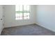 Spacious bedroom with grey carpet and a large window at 358 Olmstead Way # 25, Alpharetta, GA 30022