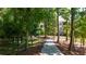 Wooded path with views of community buildings at 358 Olmstead Way # 25, Alpharetta, GA 30022