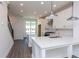 Bright kitchen featuring white cabinets, quartz countertops, and an island at 358 Olmstead Way # 25, Alpharetta, GA 30022