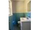 Bathroom with blue tile, toilet, vanity, and a small window at 1711 Detroit Nw Ave, Atlanta, GA 30314