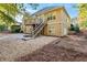 Back exterior view of house, detached garage, and gravel driveway at 147 Bayberry Hls, Mcdonough, GA 30253