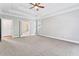 Main bedroom featuring a tray ceiling, carpet, and access to the bathroom at 147 Bayberry Hls, Mcdonough, GA 30253