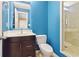 Basement bathroom with blue walls, dark wood vanity, and a shower at 950 Mill Creek Run, Suwanee, GA 30024