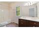 Bathroom with double vanity, shower/tub combo, and window at 950 Mill Creek Run, Suwanee, GA 30024