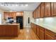 Kitchen with wood cabinets, granite countertops, and an island at 950 Mill Creek Run, Suwanee, GA 30024