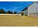 Large backyard with a gray two story home and privacy fence at 100 Leveret Rd, Locust Grove, GA 30248