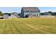 Large backyard with a gray two story home and privacy fence at 100 Leveret Rd, Locust Grove, GA 30248