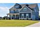 Two story home with gray siding, white trim, and a large front yard at 100 Leveret Rd, Locust Grove, GA 30248