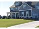 Gray siding two story home with a large grassy yard and driveway at 100 Leveret Rd, Locust Grove, GA 30248
