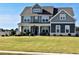 Two story home with gray siding, white trim, and a large front yard at 100 Leveret Rd, Locust Grove, GA 30248