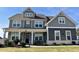 Two story home with gray siding, white trim, and a large front yard at 100 Leveret Rd, Locust Grove, GA 30248