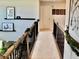 Upstairs hallway with neutral carpeting and modern decor at 100 Leveret Rd, Locust Grove, GA 30248