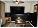Modern home office with a large TV and a desk at 100 Leveret Rd, Locust Grove, GA 30248