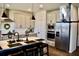 Spacious kitchen with an island, stainless steel appliances, and light cabinets at 100 Leveret Rd, Locust Grove, GA 30248