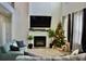 Spacious living room featuring a fireplace and large TV at 100 Leveret Rd, Locust Grove, GA 30248