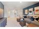 Second view of the bonus room, showing a sectional sofa and media console at 4175 Viola Pl, Atlanta, GA 30349