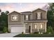 Two-story home with neutral siding, brick accents, and a two-car garage at 4175 Viola Pl, Atlanta, GA 30349