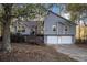 Two-story house with a gray exterior, two-car garage, and a wooden deck at 2071 Arrowhead Trl, Marietta, GA 30062