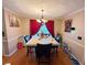 Dining room with hardwood floors, marble table and red curtains at 4761 Habersham Way, Conyers, GA 30094