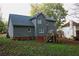 Gray two-story house with a deck and landscaped yard at 4761 Habersham Way, Conyers, GA 30094