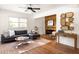 Bright living room with hardwood floors, sectional sofa, and a wood-paneled accent wall at 1531 Centra Villa Dr, Atlanta, GA 30311