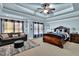 Main bedroom with sitting area, tray ceiling, and hardwood floors at 3423 Mulberry Lane Ct, Dacula, GA 30019