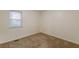 Simple bedroom with carpet and large window at 2870 Aunt Pitty Pat Ln, Douglasville, GA 30135