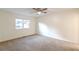 Well-lit bedroom with carpeted floors and a large window at 2870 Aunt Pitty Pat Ln, Douglasville, GA 30135