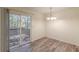 Dining room with vinyl flooring and sliding glass door access to deck at 2870 Aunt Pitty Pat Ln, Douglasville, GA 30135