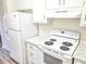 White appliances and quartz countertops in this kitchen at 2870 Aunt Pitty Pat Ln, Douglasville, GA 30135