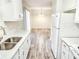 Open concept kitchen with white cabinets and flooring at 2870 Aunt Pitty Pat Ln, Douglasville, GA 30135