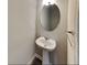 Powder room featuring a pedestal sink, an oval mirror, and modern light fixtures at 2108 Irvin Ct, Kennesaw, GA 30144