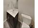 Simple, functional bathroom with dark wood vanity and white fixtures at 2108 Irvin Ct, Kennesaw, GA 30144