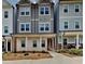 Three-story townhome with gray siding, brick accents, and a covered porch at 2108 Irvin Ct, Kennesaw, GA 30144