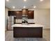 Kitchen island with granite countertops, stainless steel appliances, and dark wood cabinets at 2108 Irvin Ct, Kennesaw, GA 30144