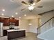 Open-concept kitchen and dining area with dark wood cabinets, stainless steel appliances, and a large island at 2108 Irvin Ct, Kennesaw, GA 30144