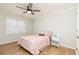 Bright bedroom with pink bedding, ceiling fan, and wood-look floors at 827 Registry Nw Ter, Kennesaw, GA 30152