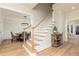 Wooden staircase with white railings, light flooring, and view of dining area at 827 Registry Nw Ter, Kennesaw, GA 30152